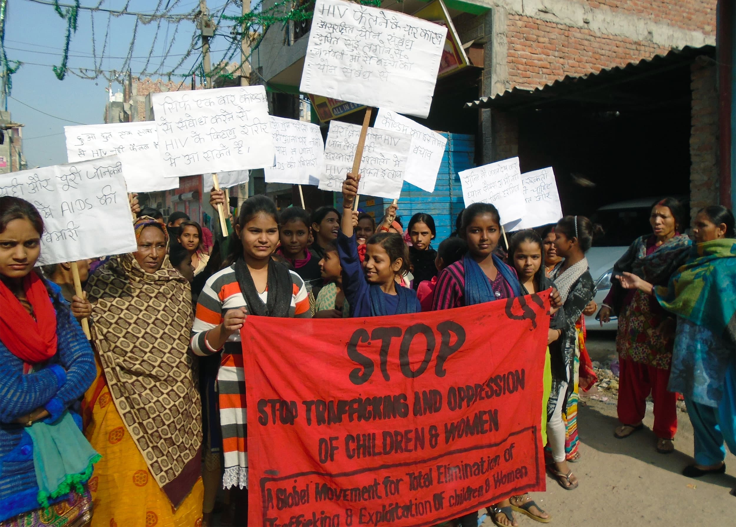 Women and girls gathered outdoors during a STOP India program.