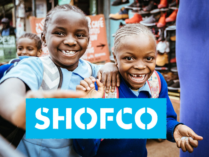 Children holding a SHOFCO sign in Kibera, Nairobi